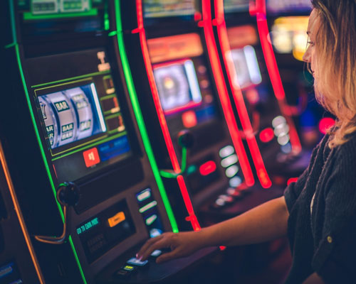 Woman at a slot machine in a casino